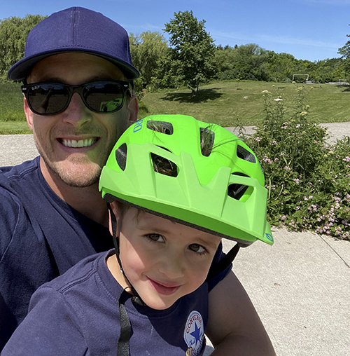 Medtronic representative Cameron Hawn bicycling with his son