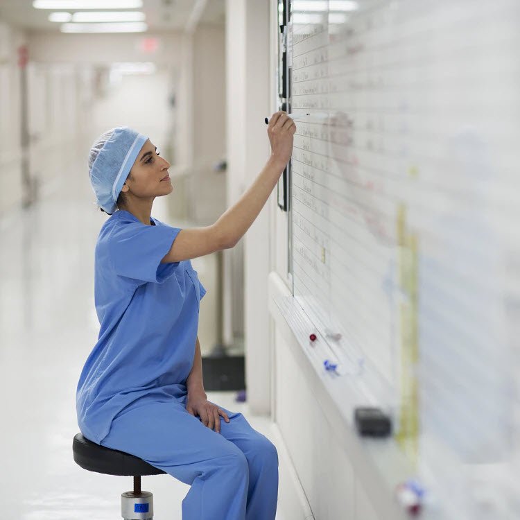 Nurse writing on whiteboard